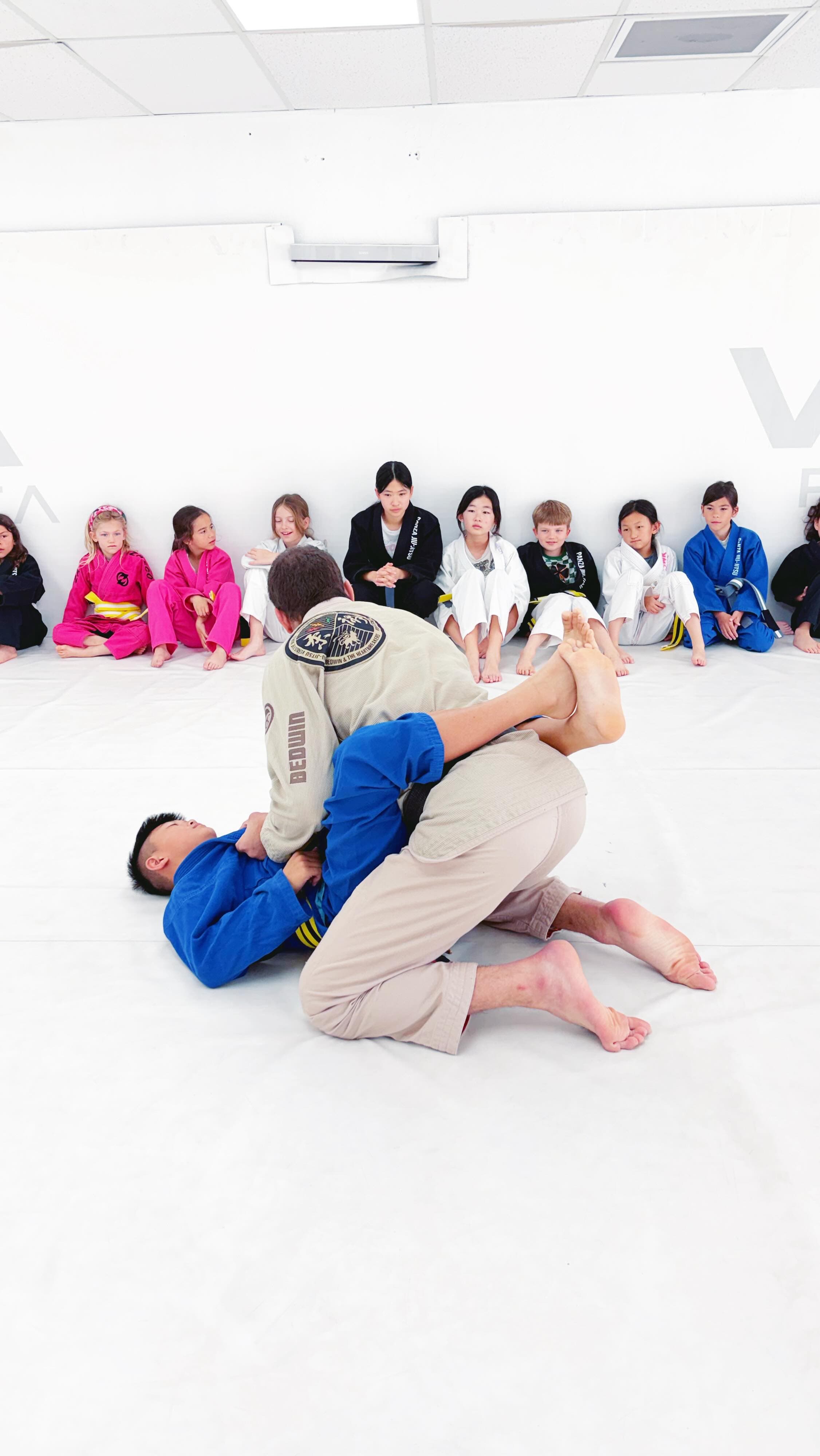 Kids class with instructor demonstrating technique at Panza Jiu-Jitsu in Torrance
